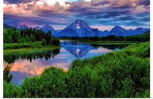 Light breaks through clouds over the Snake River at Oxbow Bend in Grand Tetons