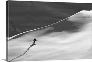 Professional snowboarder, Gigi Ruf, carrying his board up a mountain