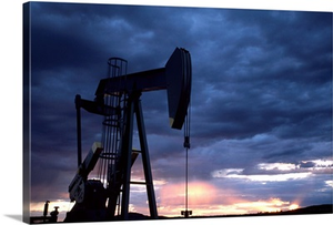 An oil rig silhouetted at sunset