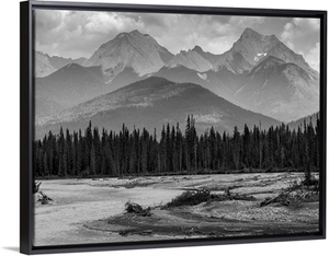 Canadian rocky mountains with a forest and a flowing river in the foreground