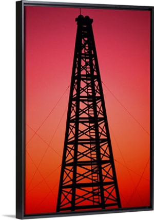 Oil drilling rig at sunset