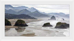 Oregon, Cannon Beach. Fog rises over coastline at low tide