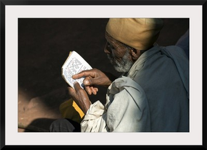 Ethiopia, Amhara, Lalibela, Monk reading Bible at Biete Abba Libanos