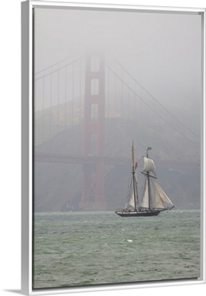 A two masted schooner sails under the Golden Gate Bridge.; San Francisco, California.