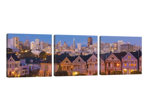 San Francisco, California, Victorian homes and city at dusk